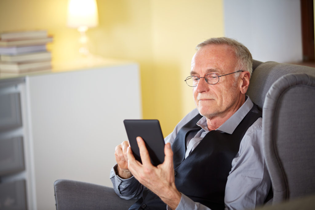 Older gentleman using digital device